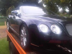 Dot Towing transportation vehicle transporting Bentley