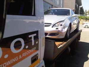 Dot Towing flat bed transportation vehicle transporting damaged vehicle