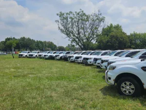 Line up of Dot Towing fleet of pick-up trucks on grass