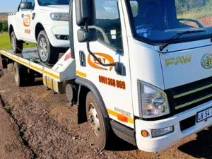 Dot Towing vehicle being transported by Dot Towing on flat bed truck