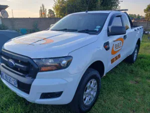 Shot of Dot Towing pick up vehicle parked on glass