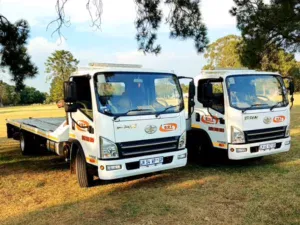 Dot Towing flat bed transportation vehicles on grass
