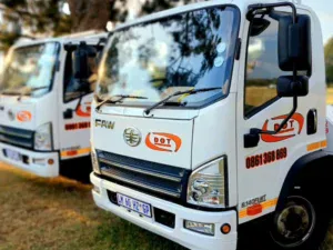 Shot of Dot Towing flat bed transportation vehicles on grass