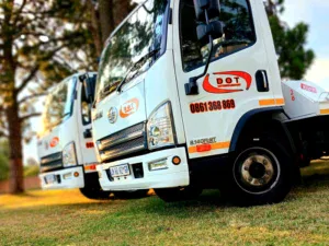 Shot of Dot Towing flat bed transportation vehicles on grass