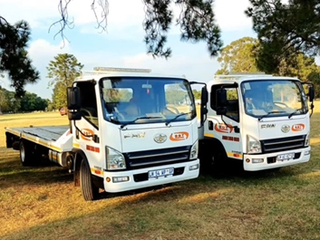 Dot Towing tow transportation vehicles on green grass